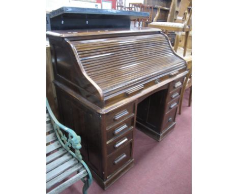 An Early XX Century Roll Top Desk ("The Lebus Desk"), with a three shaped tamber, fitted interior, central drawer, flanking p