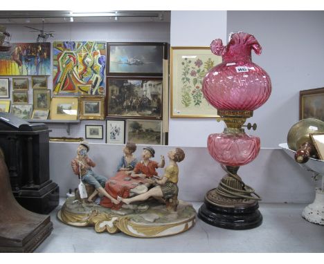 Black Glaze and Brass Based Oil Lamp, having cranberry glass well and shade (converted to electricity), Capodimonte figure gr