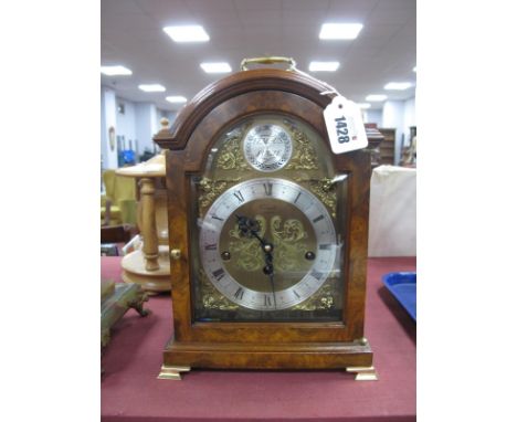 A Walnut Musical Bracket Clock (Made for Comitti of London by Kienger JO240), with a brass carrying handle domed top, silver 