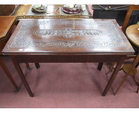 A XVIII Century and Later Mahogany Card Table, with a carved fold over top, on chamfered supports.