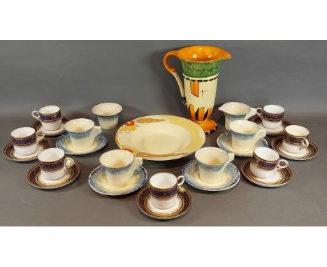 A set of four Clarice Cliff cups and saucers with matching cream jug and sugar bowl together with a Clarice Cliff bizarre pat