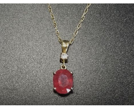 RUBY AND DIAMOND PENDANTthe oval cut ruby approximately 3cts below a round brilliant cut diamond of approximately 0.1ct, in n