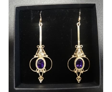 PAIR OF AMETHYST SET NINE CARAT GOLD DROP EARRINGSthe oval cut amethyst on each within decorative pierced setting