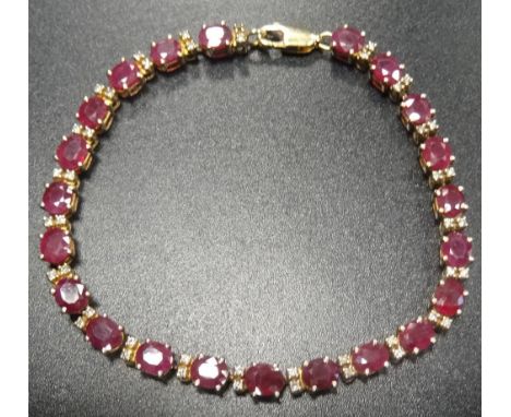 RUBY AND DIAMOND LINE BRACELETeach the twenty-two oval cut rubies separated by two small diamonds, in eighteen carat gold, 18