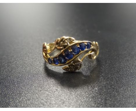 EDWARD VII SAPPHIRE AND DIAMOND RINGon eighteen carat gold shank with pierced scroll and foliate setting, ring size J-K