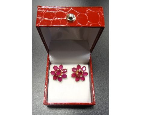 PAIR OF RUBY CLUSTER STUD EARRINGSthe floral design earrings with central round cut ruby surrounded by seven oval cut ruby 'p