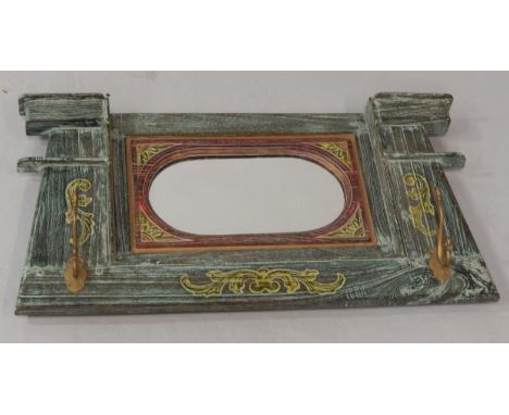 A carved and painted wooden mirror hanging bracket, with two coat hooks.