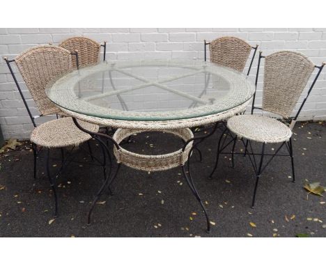 A modern dining room suite, comprising of a circular dining table with iron frame and woven rush surround and plate glass top