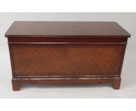 A Strongbow mahogany blanket box, with quarter veneered figured front panel on bracket feet.