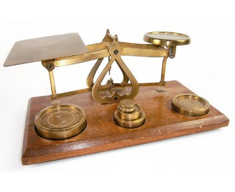 A set of brass postal scales, with weights.