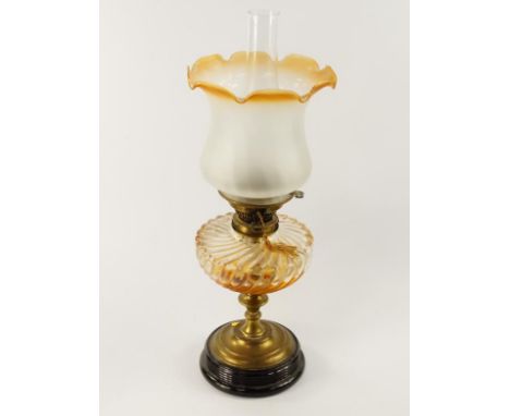 A Victorian brass oil lamp, with whorl fluted clear glass reservoir and frosted glass shade, 50cm to top of shade.