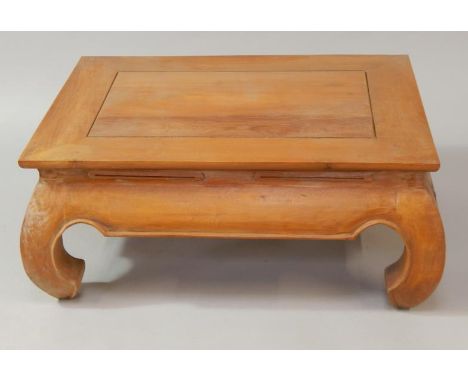 An Indonesian light hardwood rectangular coffee table, with inverted scrolling legs, 80cm x 60cm.