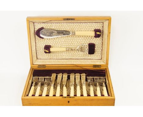 A set of twelve pairs of silver plated fish eaters, and a pair of servers, in a fitted light oak case. 