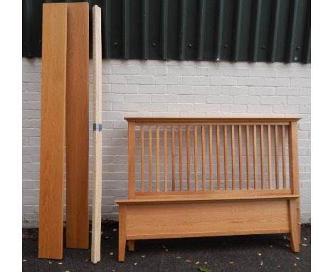 A modern light oak bed, the headboard with vertical rail supports and plain foot board, 152cm wide.