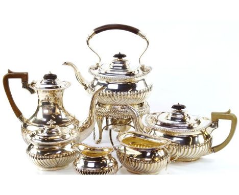 An Edwardian six piece silver tea and coffee set, comprising a tea kettle on stand with spirit burner, tea pot, coffee pot, l