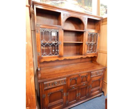 An Old Charm medium oak dresser, the back with open shelves and two cupboards with leaded light doors, the base section with 