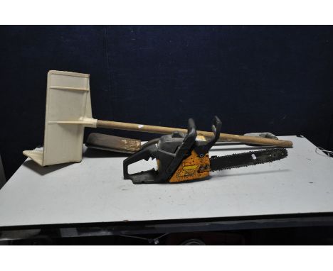 A MacCULLOCH 335 PETROL CHAIN SAW (engine pulls freely but hasn't been started) a brick hod and a distressed spade (3)