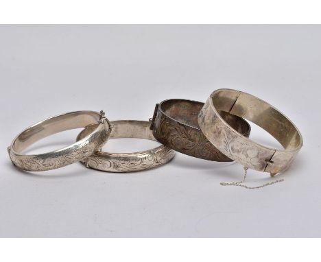 THREE SILVER BANGLES AND ONE OTHER, to include a wide hinged bangle with a decorative floral engraved design hallmarked Birmi