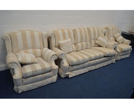 A GOLD AND CREAM STRIPPED THREE PIECE LOUNGE SUITE, comprising a settee, width 210cm, and a pair of armchairs (one stain to a