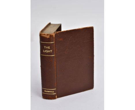 A DUNHILL NOVELTY TABLE LIGHTER, 'THE LIGHT', in the form of a book, brown leather bound with a gilt rim (Condition Report:- 
