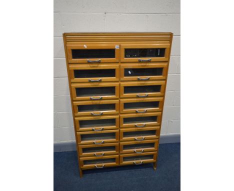 A BEECH HABERDASHERY CABINET, made up of sixteen glass fronted drawers and silvered handles, width 92cm x depth 46cm x height