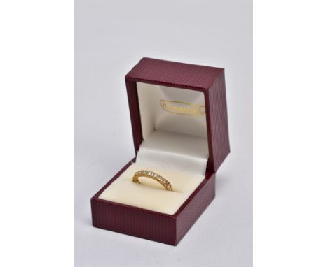 A YELLOW METAL FULL ETERNITY RING, set with circular cut colourless stones, assessed as spinels, stamped '18ct', ring size L,