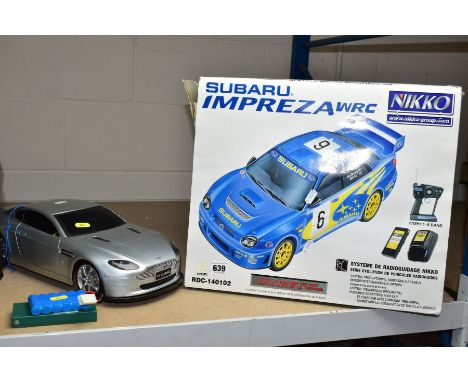 REMOTE CONTROL CARS etc, comprising a boxed Nikko Subaru Impreza RDC-140102, in used condition, complete but battery pack cas