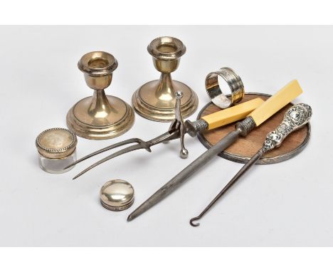 A BOX OF ASSORTED SILVER ITEMS, to include a pair of plain polished dwarf candlesticks, on round stepped weighted bases, each