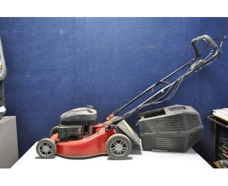 A CHAMPION SELF PROPELLED PETROL LAWN MOWER with grass box (engine pulls freely but hasn't been started)