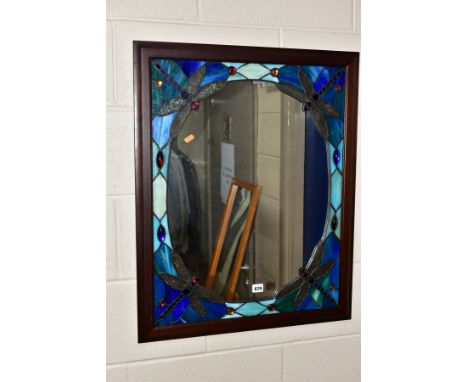 A WOOD FRAMED TIFFANY STYLE WALL MIRROR, the central mirror panel is surrounded by a repeat pattern of cut panels with Dragon
