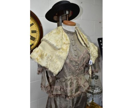 A LATE VICTORIAN GREY SILK TWO PIECE DRESS, with brown silk fringing, the skirt with stains/spotting, together with a cream m