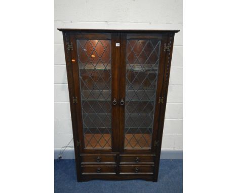 A JAYCEE OAK TWO DOOR LEAD GLAZED DISPLAY CABINET, with four drawers, and internal lighting, width 99cm x depth 42cm x height