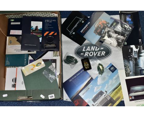 A TRAY OF LANDROVER ADVETISING EPHEMERA, ETC, to include Defender sales brochures, twelve 'Landrover' badges, pack of 28 Defe