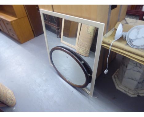 A LARGE CREAM SQUARE FRAMED WALL MIRROR AND AN OVAL FRAMED WALL MIRROR