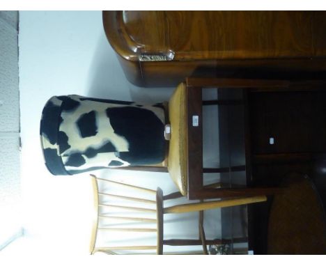 A BLACK AND WHITE FUR FABRIC DRUM SHAPED TALL TAPERING CIRCULAR STOOL, WITH WOODEN FEET AND A SINGLE CHAIR, COVERED IN LIGHT 