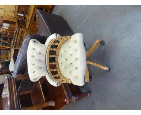 A CAPTAINS CHAIR, BUTTON UPHOLSTERED IN CREAM HIDE 