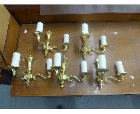 A SET OF FIVE BRASS TWO LIGHT WALL BRACKETS WITH CANDLE PATTERN SCONCES AND FABRIC SHADES 