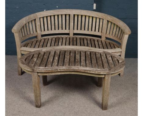 A carved hardwood garden seat and matching table. (height 85cm, width 155cm, depth 64cm).  