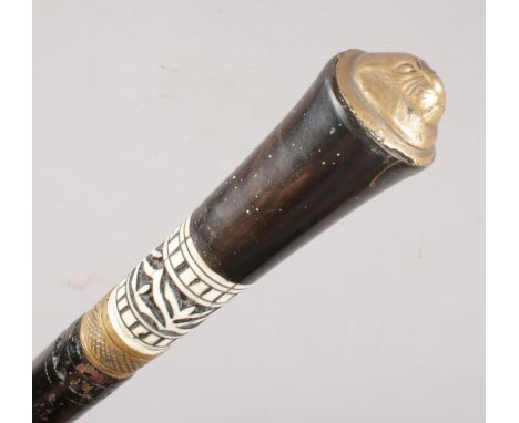 A Victorian ebonised sword stick. With brass lion mask pommel.  