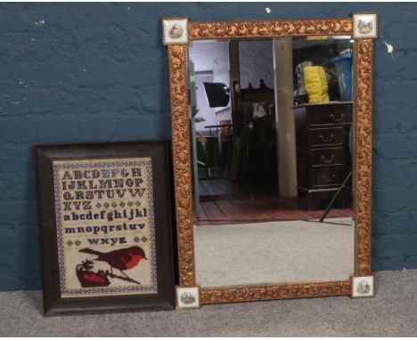 An Atsonea gilt bevelled mirror together with a framed sampler. Mirror: H: 88cm, W: 63cm. Sampler: H:41cm x W:29cm.  Conditio