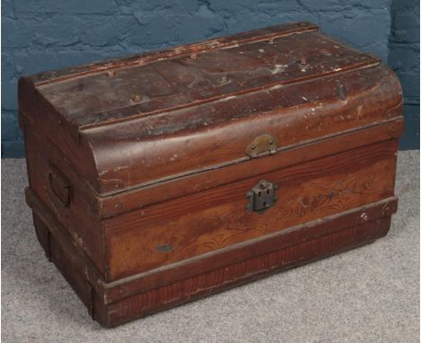A dome top twin handled tin trunk.  