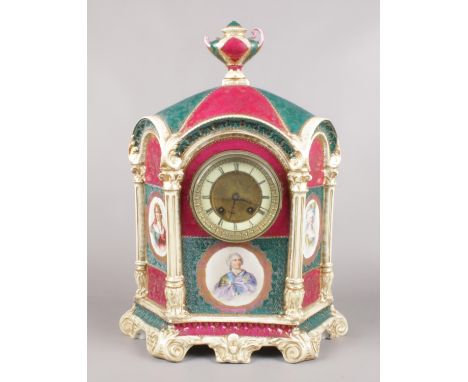 A large decorative pottery mantel clock. Decorated with figural panels depicting Louis XV, Duchess De Montepan and one other.