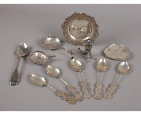 A collection of silver items, five Chinese tea spoons each with Shou roundels, Cornucopia pepper pot, silver teaspoon, 1902 K