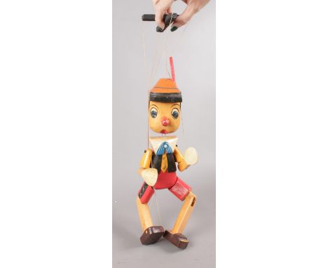 A wooden hand painted Pinnochio puppet. (45cm length)  