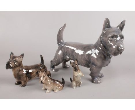 A collection of ceramic Scottish Terrier dogs. Includes three Royal Doulton and one Royal Copenhagen example.  