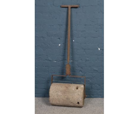 A vintage cast iron and heavy concreate garden roller. H: 140cm, W:44.5cm.  Condition age worn.