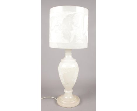 A large alabaster table lamp with floral decoration. (Height 59cm).  