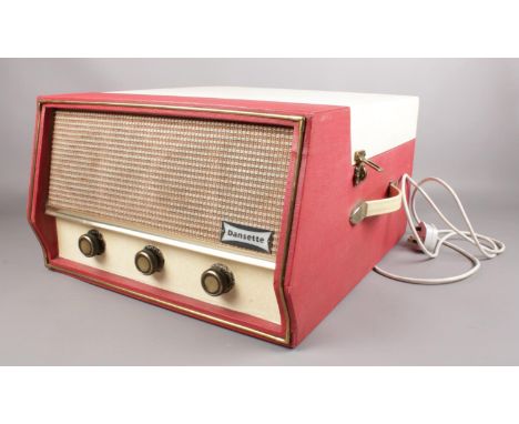 A Dansette 'Conquest Auto' portable record player (missing legs) in red and cream. H:25.5cm, W: 40.5cm, D: 45.5cm.  Condition
