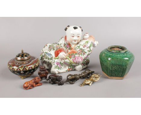 A selection of oriental items - to include a ceramic figure holding a fish, three carved hardwood animals (Owl, Monkey &amp; 