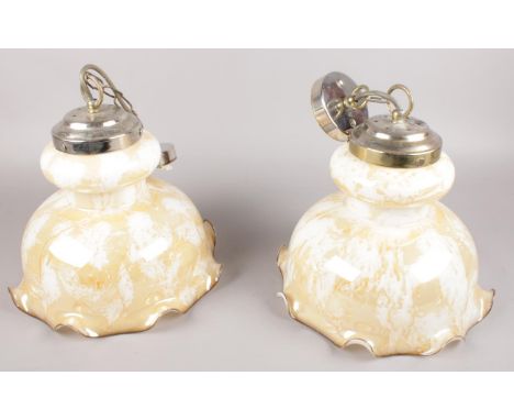 A pair of coloured glass light fittings.  